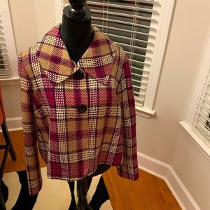 Plaid jacket with two large buttons.